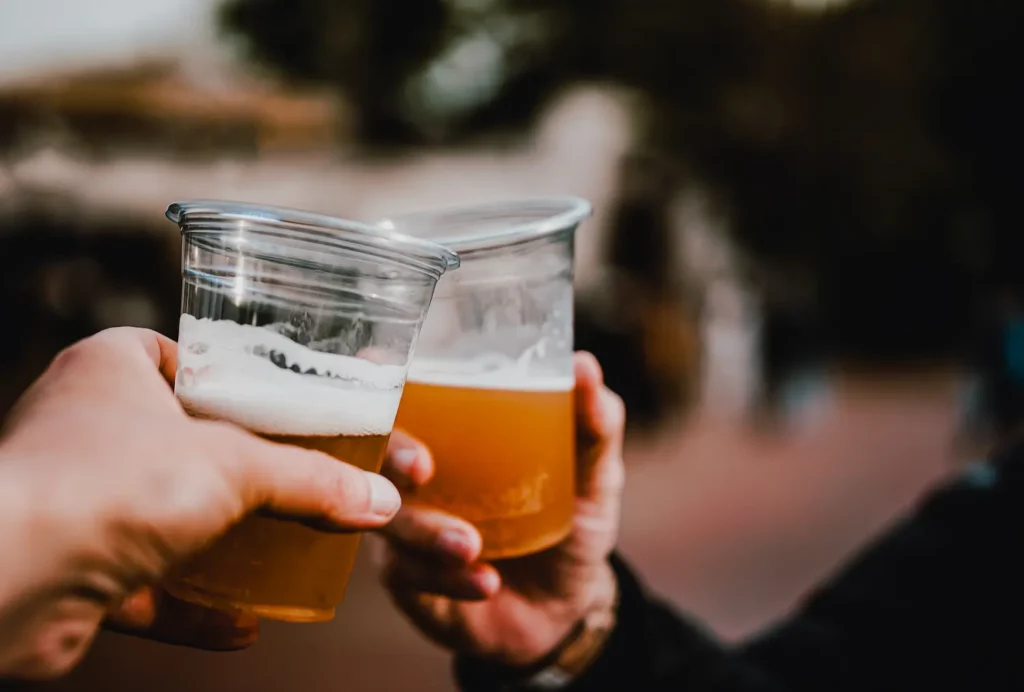 Duas pessoas brindando cerveja